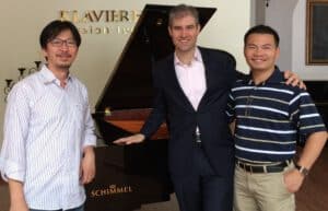 From left to right: Nguyen Hong Minh, founder of Erato Corporation; Michael B. Horn; and Nguyen Thanh Vinh, an Eisenhower Fellow and president and founder of several businesses, including Bespoke Tailoring. Vinh sends his children to Erato Corporation to experience a more wholesome education than he was able to receive as a child.